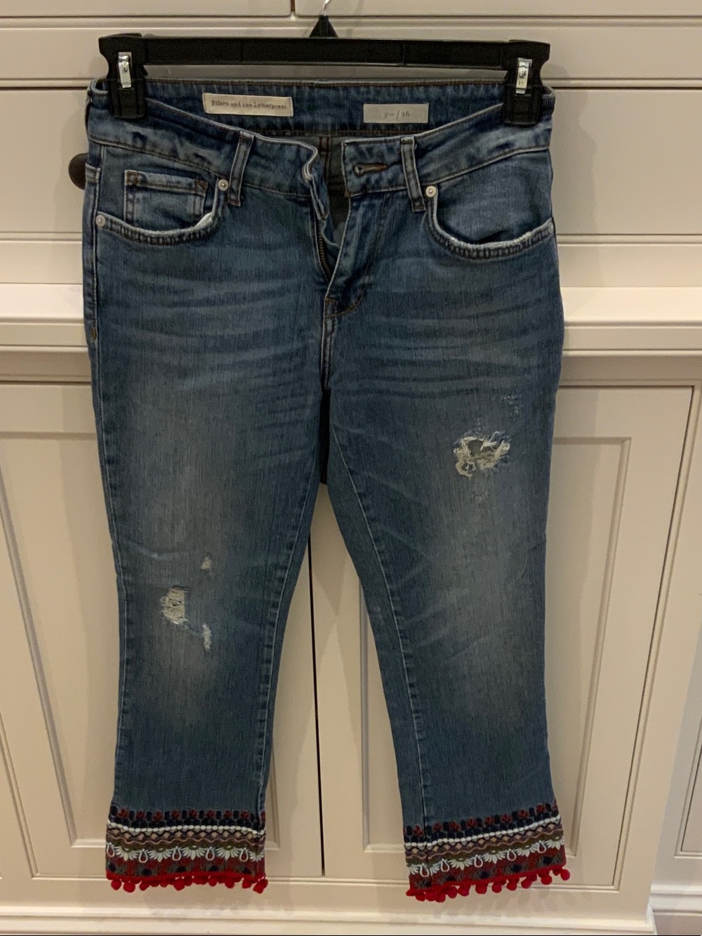 Pilcro Cropped Blue Distressed Jeans with Embroidered Pom Trim